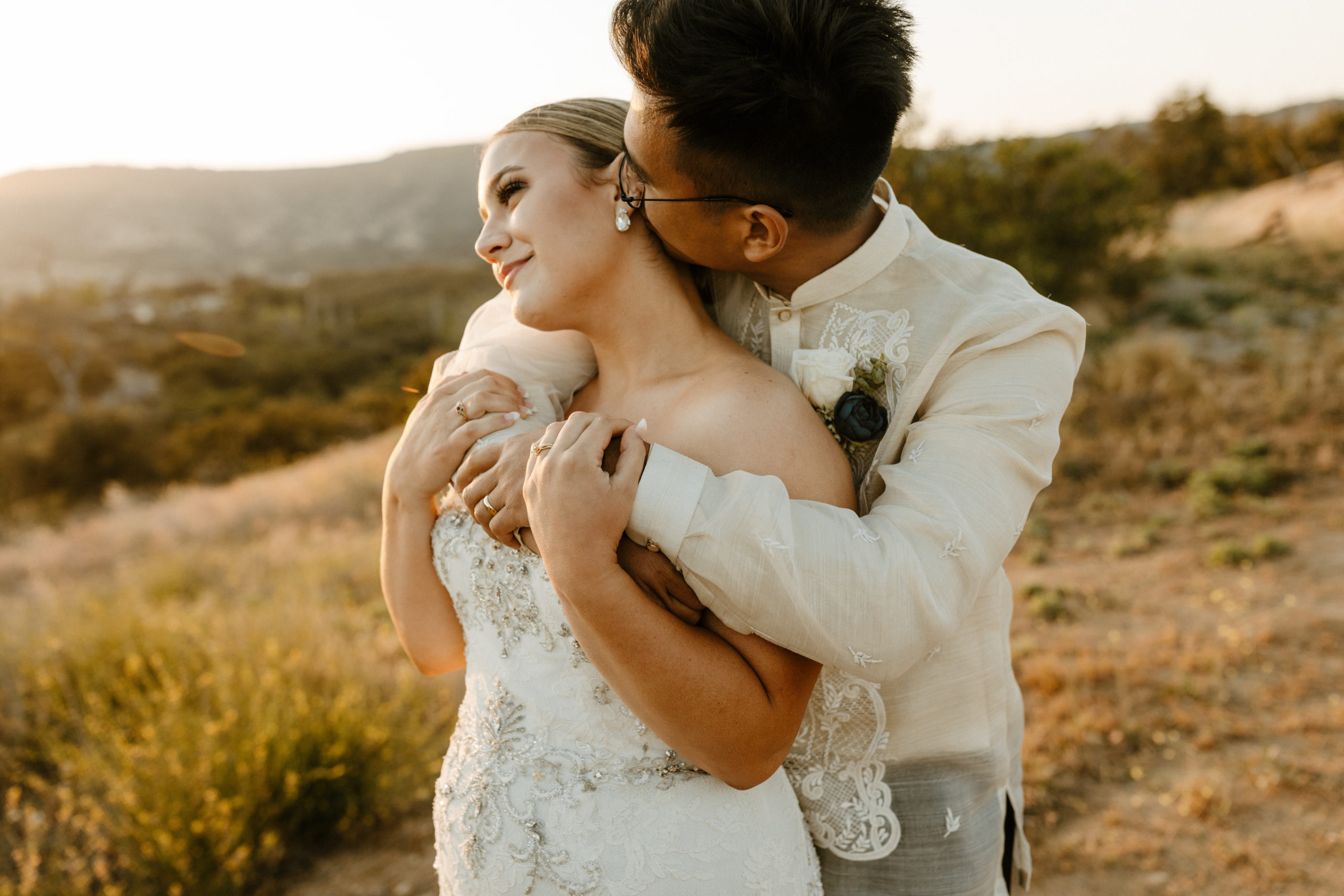 Wedding couple embracing in the hills of temecula